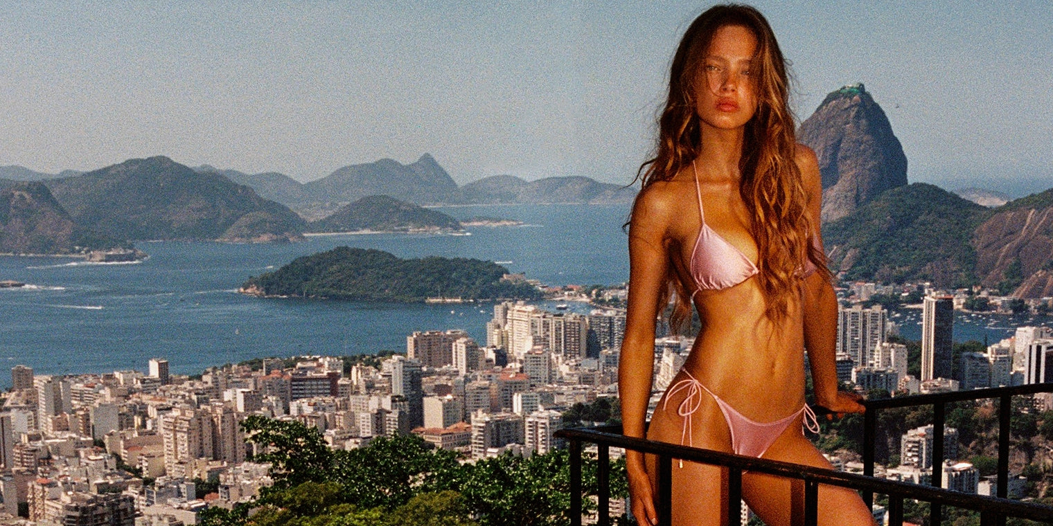 Model wearing tie side bikini bottoms on the beach.